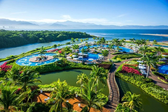 Here are the top 5 hotels in Puerto Vallarta, including Vidanta: 1. **Vidanta Puerto Vallarta**: Offering a blend of quality, comfort, and romance, Vidanta Puerto Vallarta provides a range of luxurious accommodations and amenities. Situated amidst stunning coastal landscapes, this resort is renowned for its scenic beauty and upscale offerings. 2. **Hotel Mousai**: Nestled on the pristine shores of Banderas Bay, Hotel Mousai boasts contemporary elegance and unparalleled luxury. With its lavish suites, gourmet dining options, and panoramic views of the Pacific Ocean, Hotel Mousai provides an unforgettable retreat for discerning travelers. 3. **Garza Blanca Preserve Resort & Spa**: Surrounded by lush tropical forests and crystal-clear waters, Garza Blanca Preserve Resort & Spa offers a tranquil sanctuary away from the hustle and bustle of city life. Guests can indulge in world-class spa treatments, gourmet cuisine, and outdoor activities amidst the beauty of nature. 4. **Grand Miramar All Luxury Suites & Residences**: Perched on the hills overlooking Puerto Vallarta, Grand Miramar All Luxury Suites & Residences offers breathtaking views of the bay and the city skyline. With its spacious suites, infinity pools, and attentive service, this hotel provides a luxurious escape for travelers seeking comfort and sophistication. 5. **Casa Velas**: Tucked away in the exclusive Marina Vallarta neighborhood, Casa Velas combines colonial charm with modern amenities to create a truly enchanting experience. Featuring lush gardens, gourmet dining, and a serene atmosphere, Casa Velas is a haven of relaxation and tranquility.